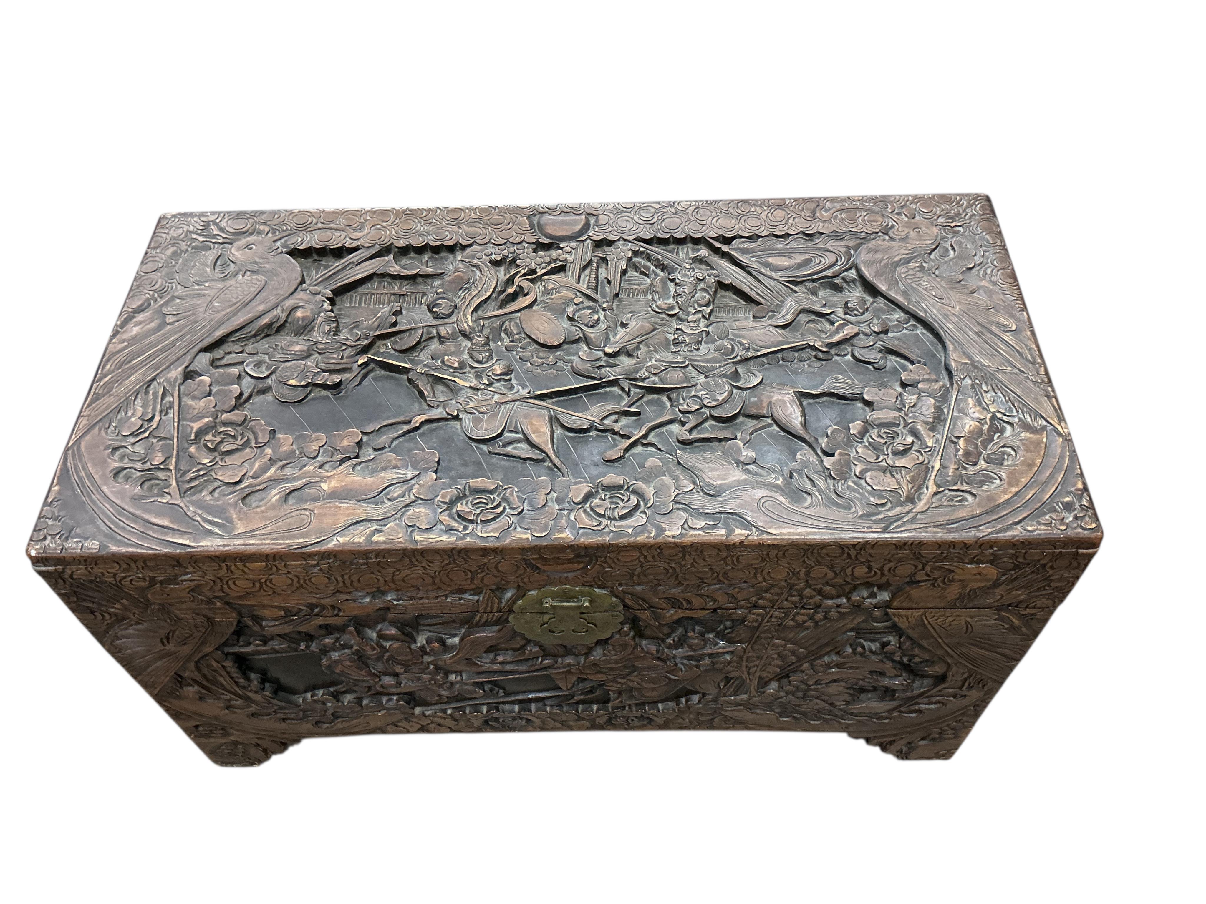 A Chinese carved camphorwood trunk, width 97cm, depth 47cm, height 54cm